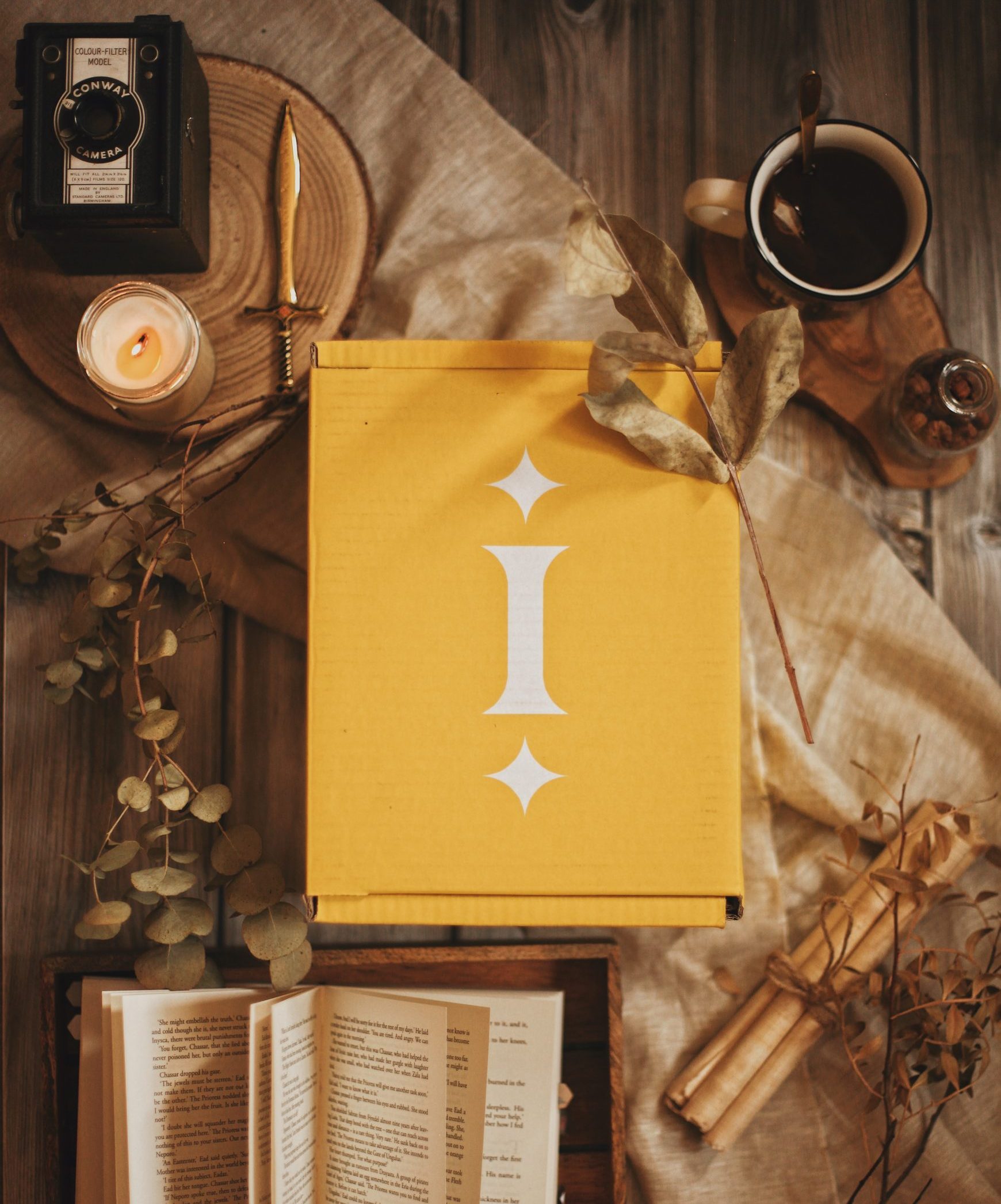 A yellow Illumicrate box on a table surrounded by old items